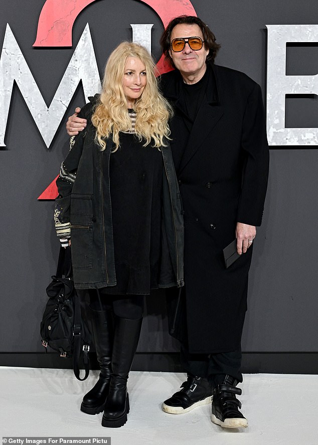 She wore her long blonde tresses in loose waves and opted for understated makeup as she posed with Jonathan.