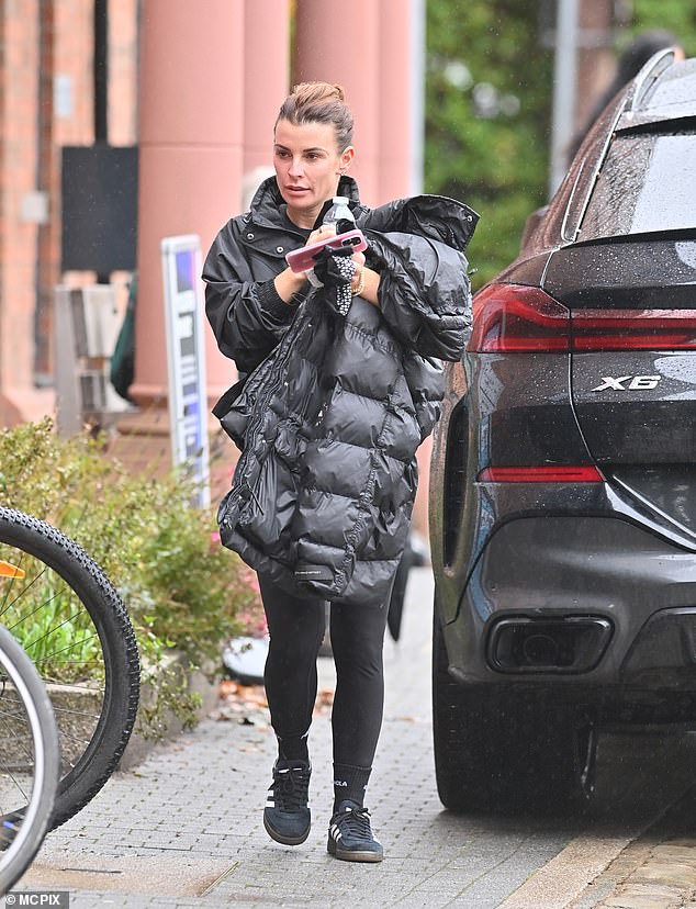 The WAG, 38, cut a casual figure as she left the gym, dressed in a pair of tight leggings and a black raincoat.