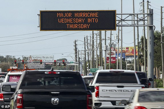 Highway signage announces the imminent arrival of Hurricane Milton and evacuation zones Tuesday, Oct. 8, 2024, in Port Richey, Fla. (AP Photo/Mike Carlson)