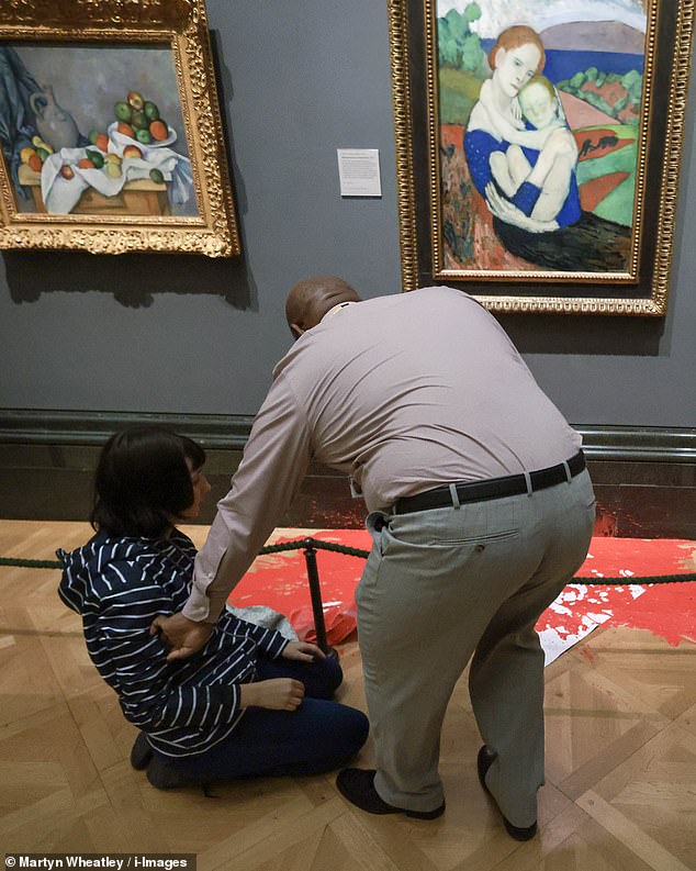 The couple also threw red paint on the gallery floor.