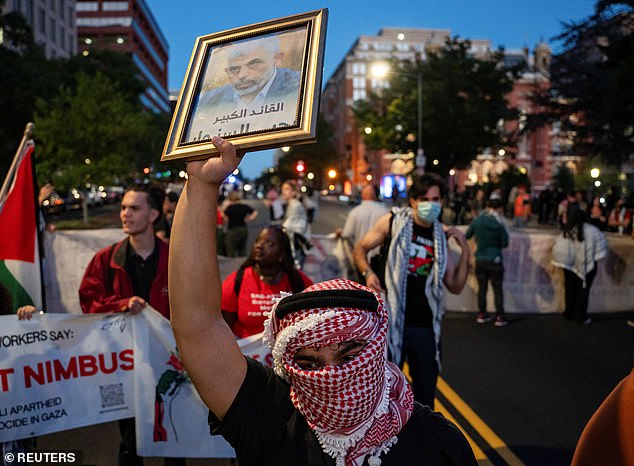 A pro-Palestinian protester holds a photograph of Hamas leader Yahya Sinwar during a march ahead of the anniversary of the October 7 attack near the White House in Washington.