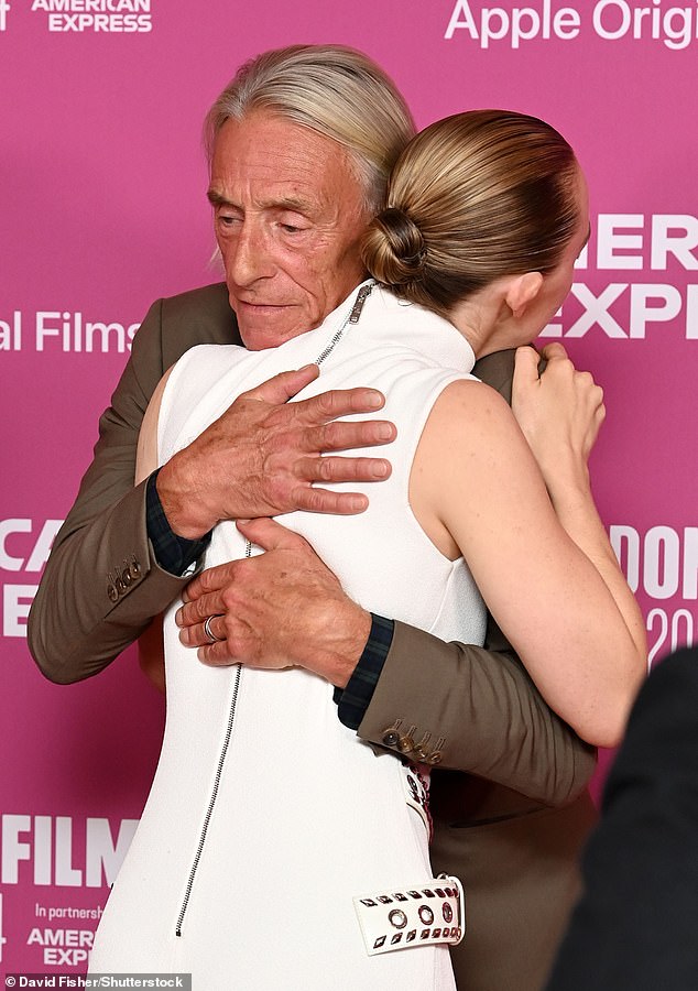 The actress was in good spirits as she hugged her co-star Paul Weller.