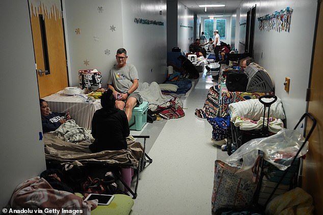 (Above) Hundreds of people shelter at Virgil Mills Elementary School ahead of Hurricane Milton, in Palmetto, Florida.