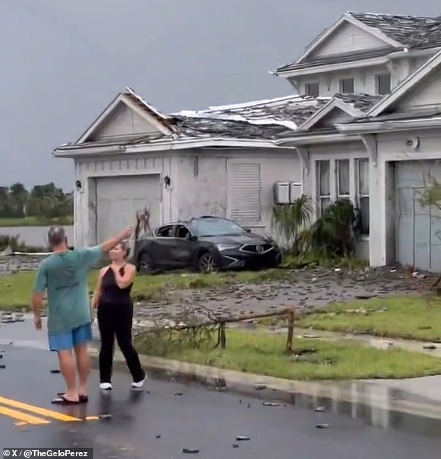 Lawns were covered in debris and cars in the neighborhood were severely damaged.