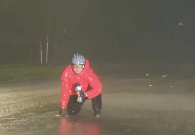 At one point, a waterlogged Ray was forced to crouch on the ground because the winds were so strong.