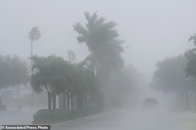 A Lee County sheriff's deputy patrols the streets of Cape Coral, Florida, as heavy rain falls ahead of Hurricane Milton, Wednesday, Oct. 9, 2024. (AP Photo/Marta Lavandier)