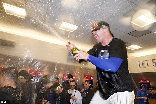 Alonso is seen spraying champagne in the Mets clubhouse after advancing to the National League Championship Series.