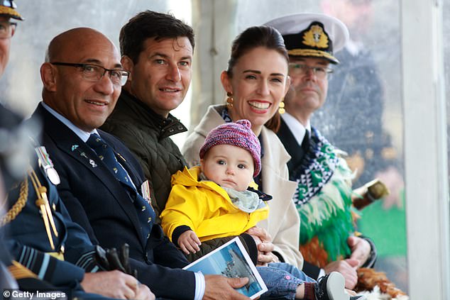 Commander Gray took the helm of HMNZS Manawanui in 2022 after then-Prime Minister Jacinda Ardern gave a speech before releasing a bottle of champagne to dip the bow at the ship's commissioning (pictured: Ms Ardern with his then partner Clarke Gayford and their 11-month-old daughter Neve at the official ceremony at Devonport Naval Base)