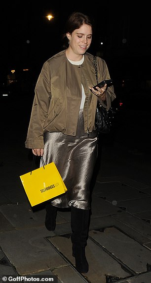 Holding a small Selfridges bag in one hand, in the other she held her phone, which she was photographed using as she left the luxury London restaurant.