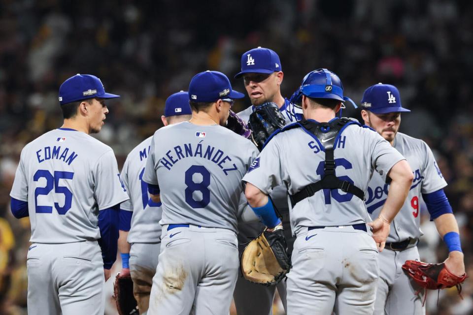 Dodgers reliever Blake Treinen's teammates visit him on the mound during an 8-0 win over the Padres at Petco Park.