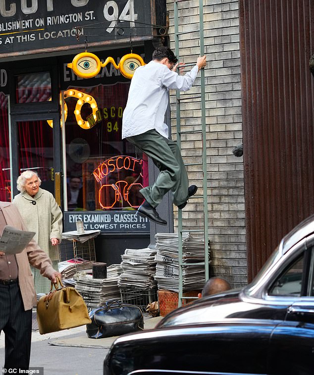 Timothée could be seen weaving around the extras to reach a fire escape and climbing up the side of the building, as if he were being chased.