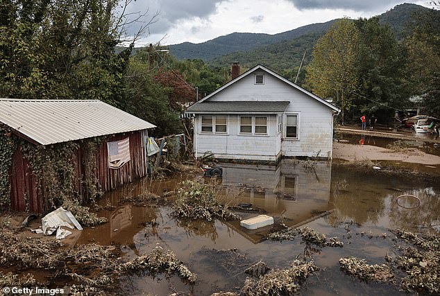 An American flag hangs over floodwaters left over from Hurricane Helene in Swannanoa, North Carolina.