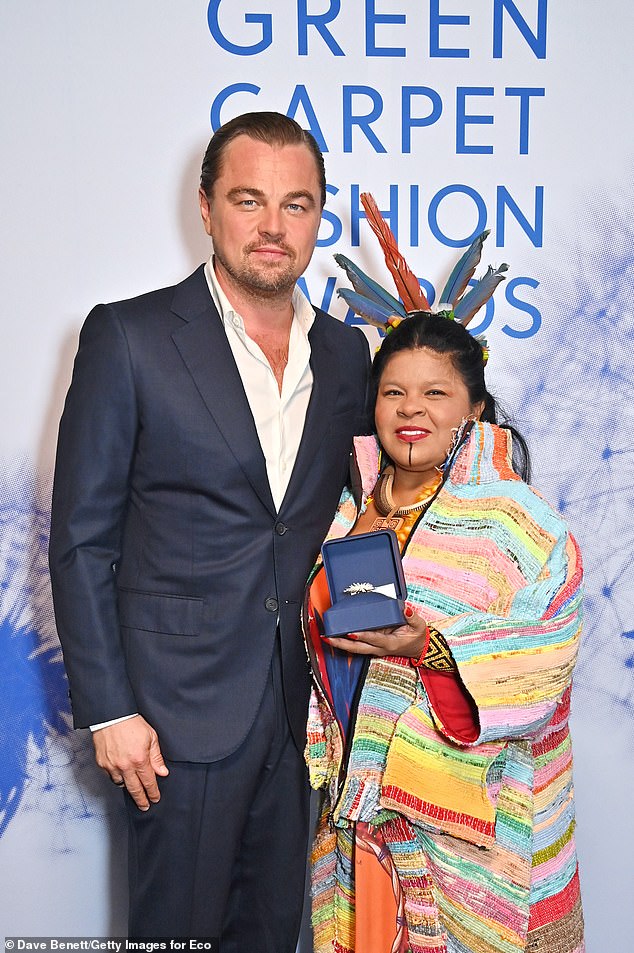 Ridiculed for an 8,000-mile private jet trip in 2016 to accept an environmental award, the star traveled commercially to the 2021 COP26 summit (pictured with Sonia Guajajara)