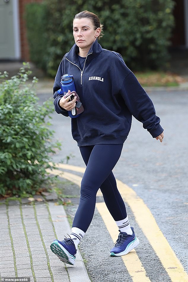 The WAG, 38, failed to manage a smile as she prepared for the cool weather while out and about in the morning.