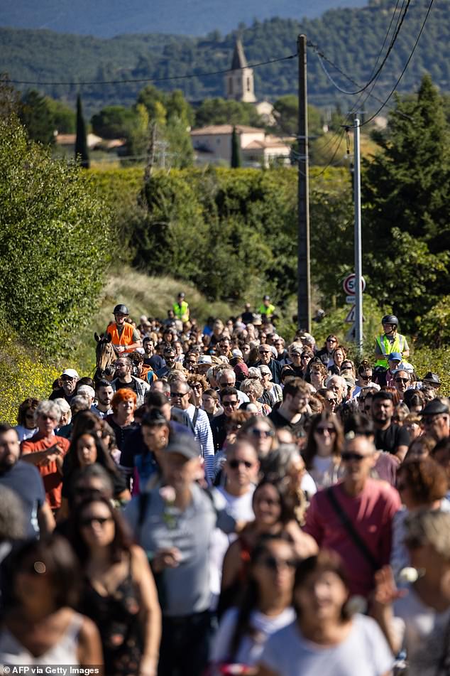 People take part in a march in and around Mazan, southeastern France, to support Gisele Pelicot and protest against violence against women, on October 5, 2023.