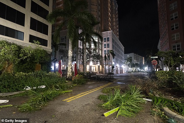 Storm debris blocks a road in Sarasota, Florida, on Thursday, just hours after Hurricane Milton passed through the area.