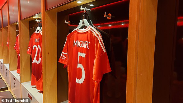 The tour group meets in the players' locker room