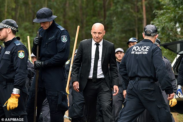 Former detective Jubelin, above in his trademark black suit, on a tour of a police search in Kendall in 2018 for the remains of missing boy William Tyrrell.