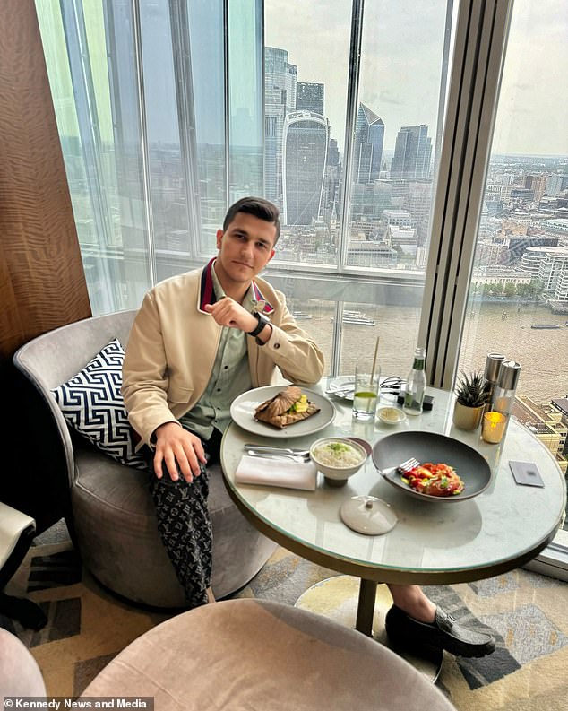 Ali photographed dining at a restaurant overlooking the London cityscape