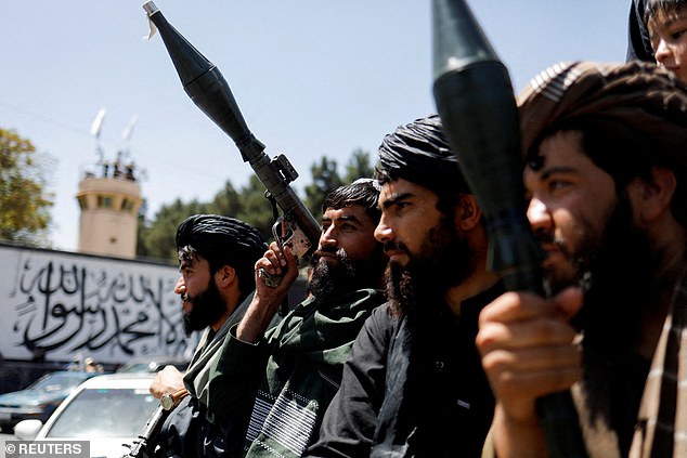 Taliban soldiers celebrate the second anniversary of the fall of Kabul on a street near the US embassy in Kabul, Afghanistan, August 15, 2023.