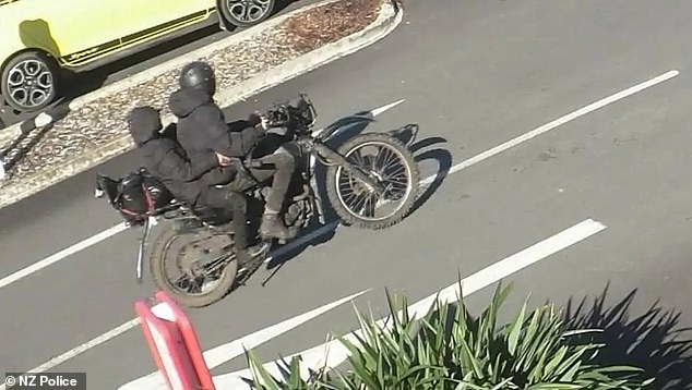 He was seen with what appears to be one of his children after allegedly robbing the bank and fleeing on a stolen motorcycle (pictured).