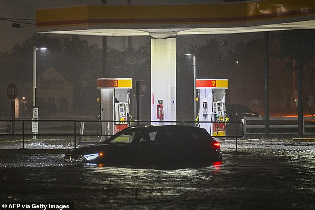 A vehicle is stranded on a street flooded with water after Hurricane Milton makes landfall in Brandon, Florida, on October 9, 2024. Milton made landfall in Florida on October 9, 2024