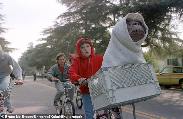 The 51-year-old comedian dressed as Elliott from ET, with an ET model plastered in front (pictured, Elliott and ET from the 2014-inspired film).