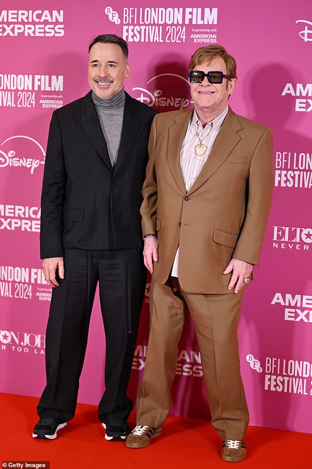 Sir Elton's husband David looked full of pride as he supported his beloved husband on the red carpet.