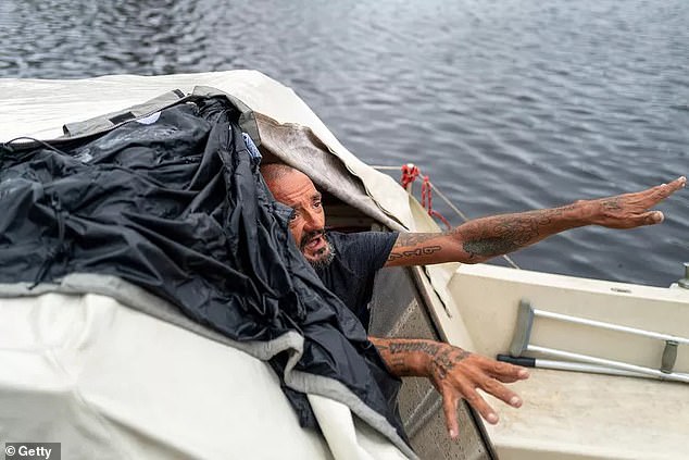 The sailor appears on Thursday after surviving the storm on his boat