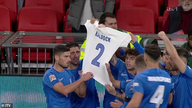 His teammates held aloft a white T-shirt with Baldock's name on it after the defender died at age 31.