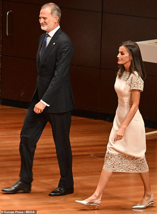 King Felipe (pictured, left) looked dapper in a black suit, white shirt and blue tie, as he attended tonight's awards ceremony in Madrid with Queen Letizia (pictured, right).