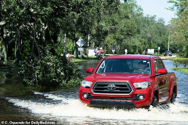 A truck battles flooding on West Hillsborough Avneue in Tampa. Woodfield describes how residents returned to living their normal lives 