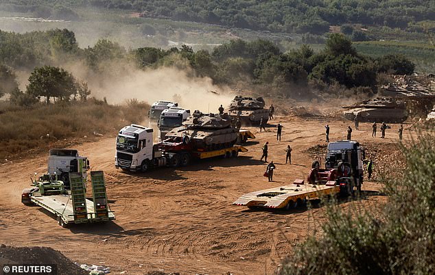 An Israeli army tank is transported, amid cross-border hostilities between Hezbollah and Israel, in northern Israel, on October 10, 2024.