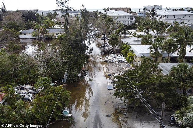 A street flooded with debris is seen after Hurricane Milton in Siesta Key, Florida.