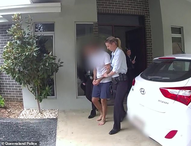 He is pictured being escorted from his home in Queensland on Thursday.