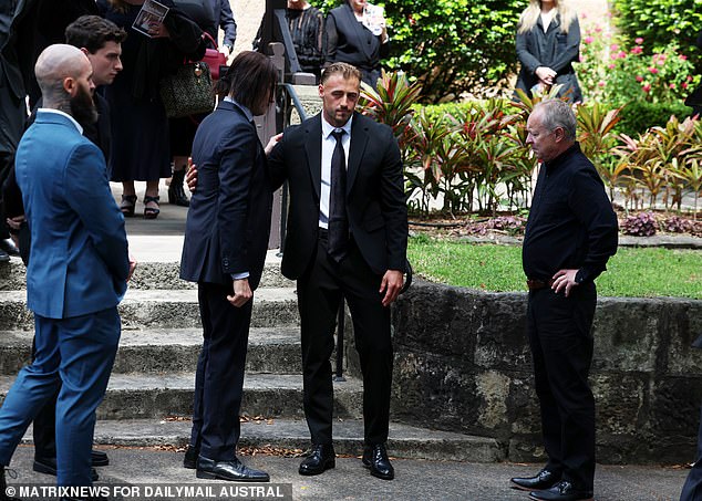 Brother James is comforted outside St Mark's Church in Darling Point