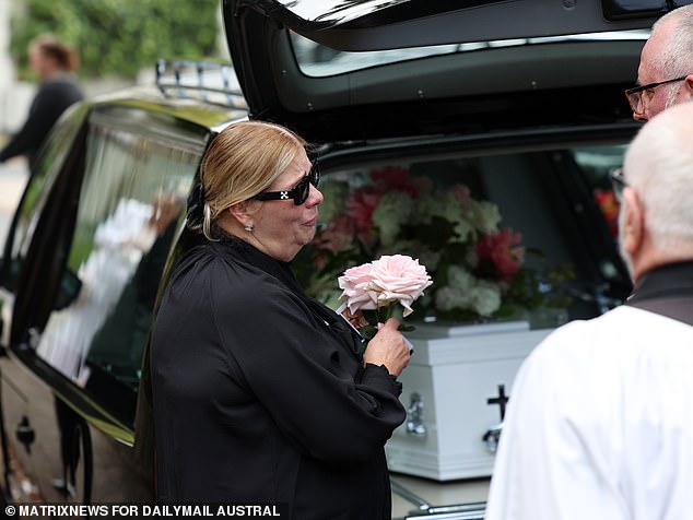 Savana's coffin was covered in pink and white flowers (her devastated mother Tatjana is pictured)