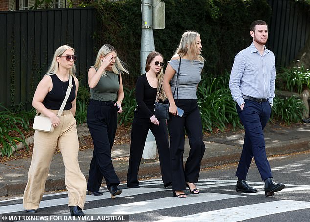 Friends of Savana Calvo cross the street towards the church of San Marcos