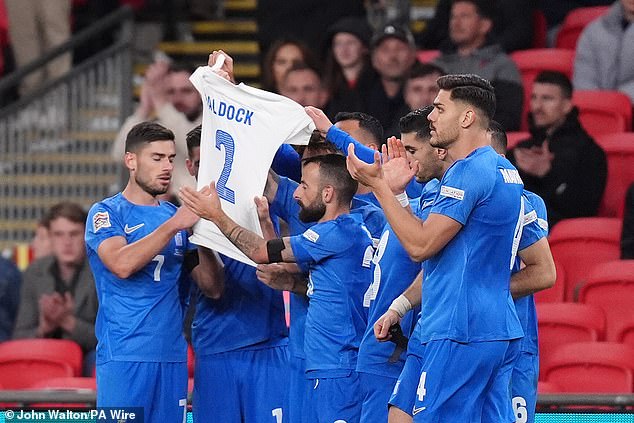 His teammates held aloft a white T-shirt with Baldock's name after the defender's death at age 31.