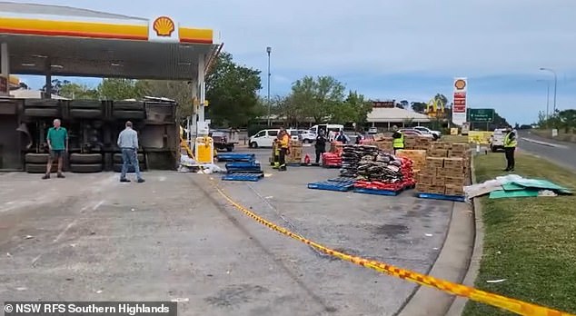 Crews are seen present at the truck rollover at a Sutton Forest servo in New South Wales.