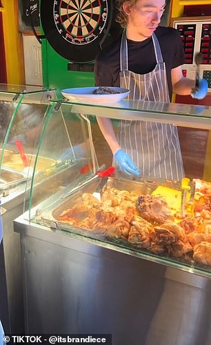 Piles of potatoes, steamed vegetables and pieces of meat are served on a counter that customers pick up themselves.