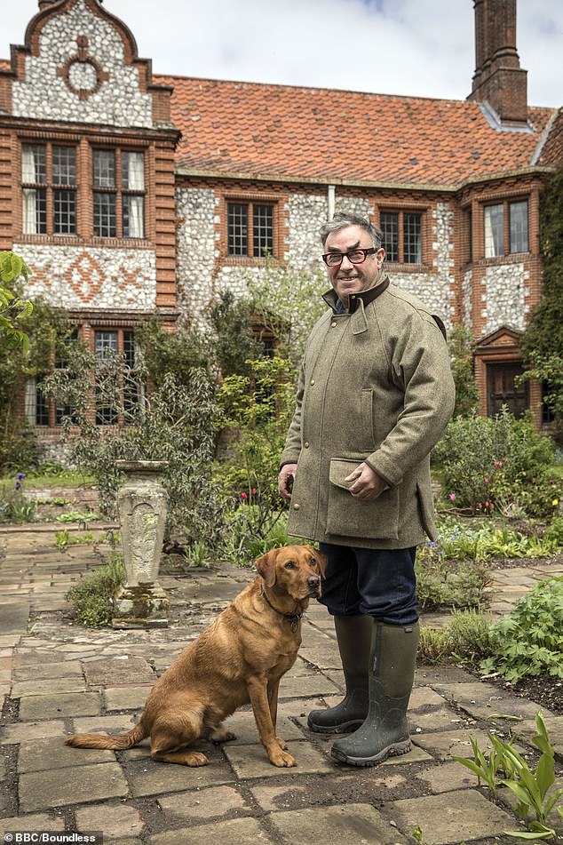 Desmond MacCarthy on the set of Normal for Norfolk with his dog Roly, standing outside Wiveton Hall