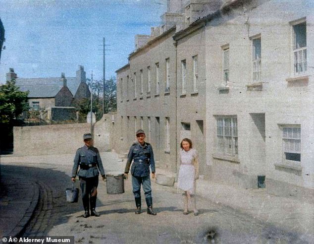 Nazi soldiers with a woman on the island in 1942.