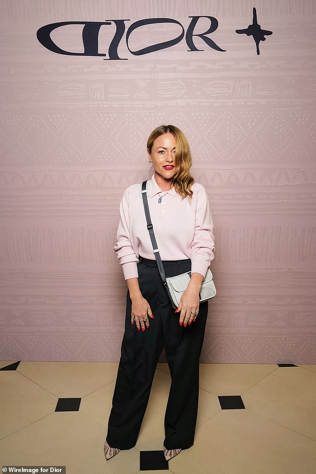 Jaime Winstone looked chic in a pink knit sweater, black pants and pointy heels.