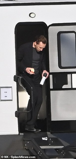 Tom was seen leaving his trailer with his water and an apple.