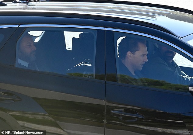 Tom was seen sitting in the front seat of the car.