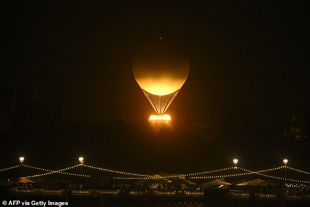 The cauldron, with the Olympic flame lit, takes off attached to a balloon, during the opening ceremony of the Paris 2024 Olympic Games