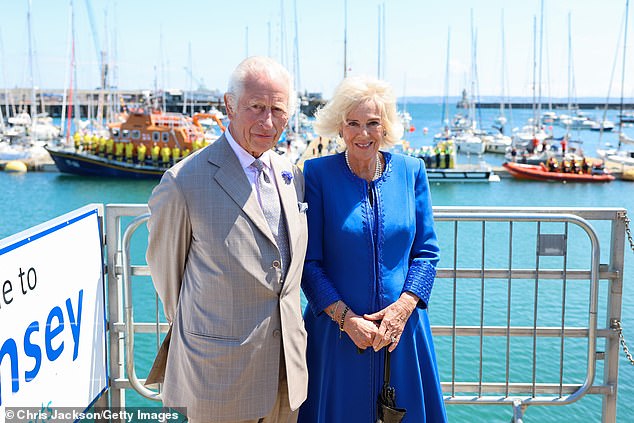 King Charles III and Queen Camilla pose in front of RNLI lifeboats during an official visit to Guernsey on July 16.