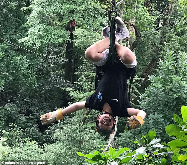 Salma uploaded additional photos of her stepson over the years, including one hanging upside down on a zip line in a forest.