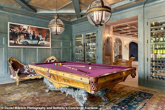 There's plenty of time to entertain with a purple pool table in the game room.